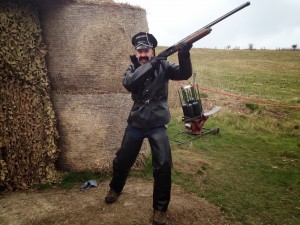 stag in ymca fancy dress outfit with clay pigeon rifle
