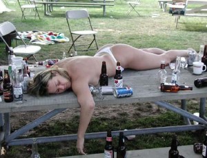 girl drunk and asleep on bbq table outside