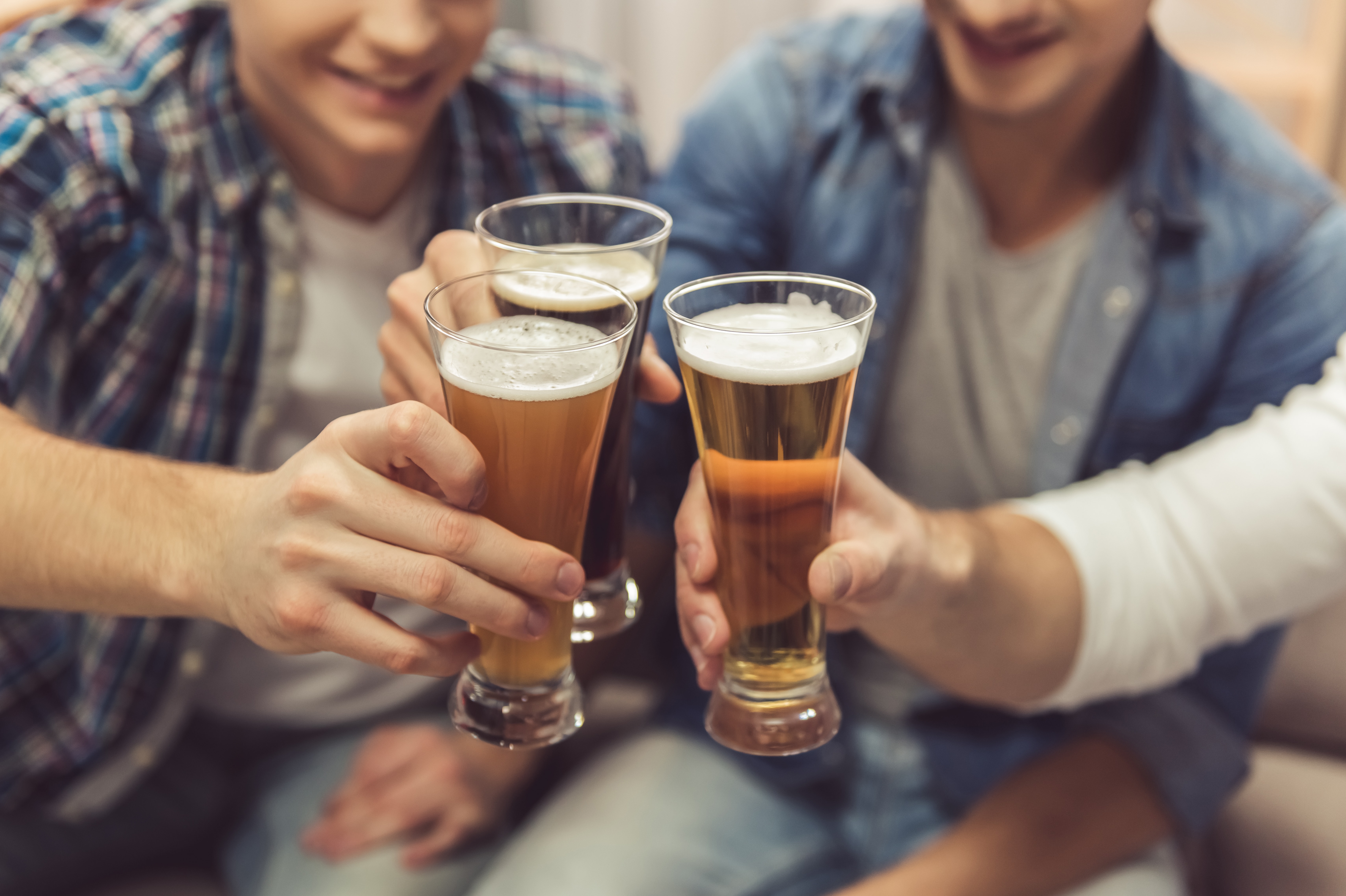 men holding up beer men holding up beer