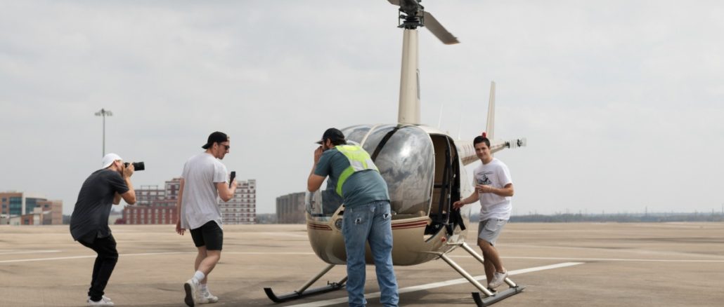 group of men in front of a helicopter group of men in front of a helicopter
