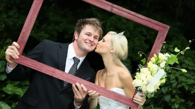 bride and groom in a wooden frame