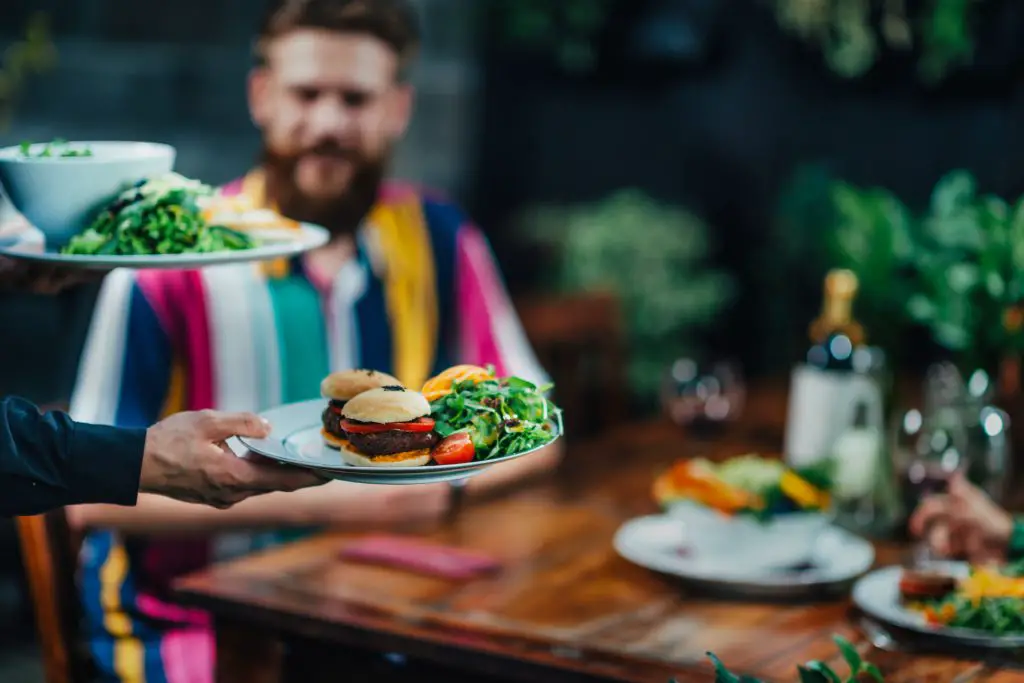 vegetarian burgers and salads being served